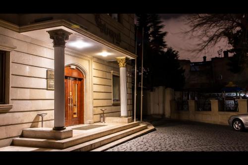a front door of a building with a pillar at Atropat Old City Hotel in Baku