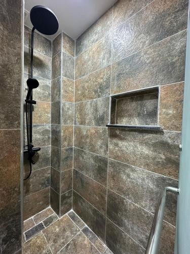 a bathroom with a shower with a glass door at The HQ in Hydra