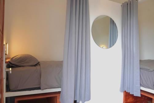a bedroom with a bed and a mirror at Tipsea Turtle Gili Trawangan in Gili Trawangan
