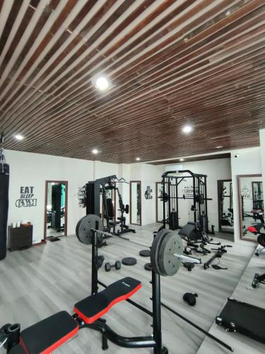 a gym with several treadmills and weights at Avery Le Nixsun Villas Ungasan with Free access to Gym center by Waringin Hospitality in Uluwatu