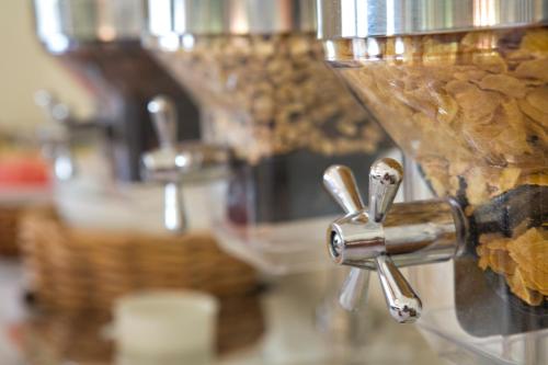 a close up of a counter with sinks and faucets at Stratos Hotel in Afitos