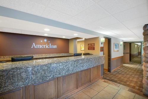 eine Lobby eines amerikanischen Gasthofs mit einer Rezeption in der Unterkunft AmericInn by Wyndham Lincoln North in Lincoln