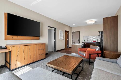 a living room with a flat screen tv on a wall at Running Aces Hotel & Casino, Trademark Collection by Wyndham in Forest Lake