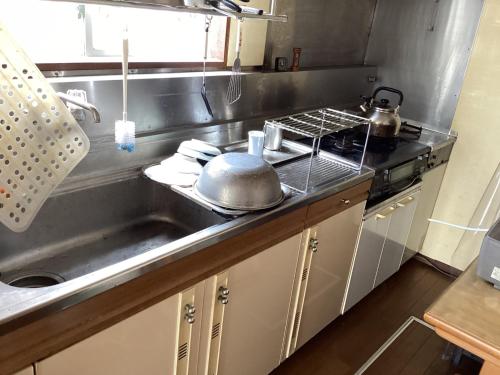 a kitchen with a sink and a pot on the counter at Ichihara city house - Vacation STAY 19155 in Ichihara