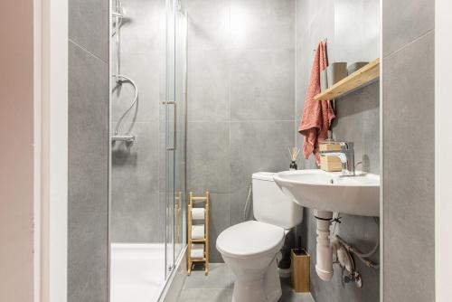 a bathroom with a shower and a toilet and a sink at Gauja forest retreat in Gauja