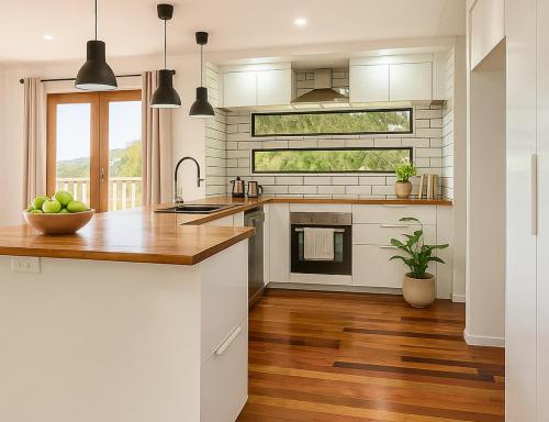 a kitchen with white appliances and a wooden floor at Patricks Road Ferny Hills in Ferny Hills
