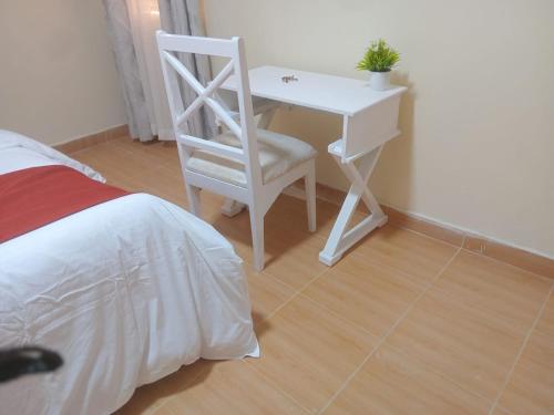 Ένα ή περισσότερα κρεβάτια σε δωμάτιο στο Oasis gardens Deliverance road