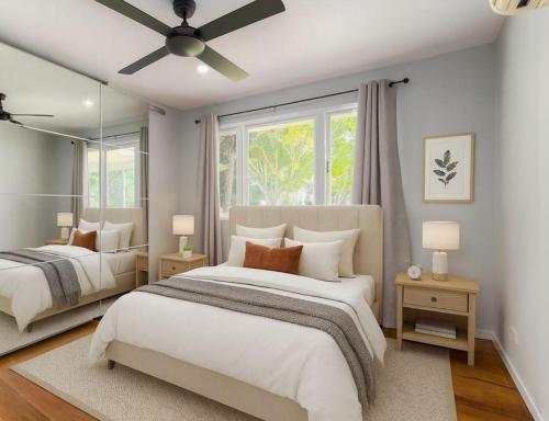 a bedroom with two beds and a ceiling fan at Patricks Road Ferny Hills in Ferny Hills