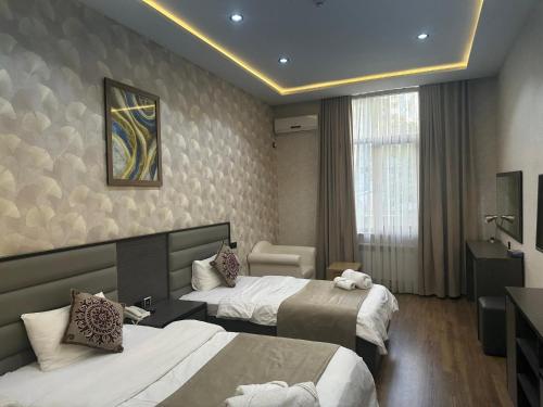 Postel nebo postele na pokoji v ubytování Vatan Hotel