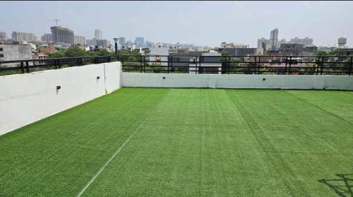 a baseball field on the roof of a building at Rusha Stays in Gumgaon