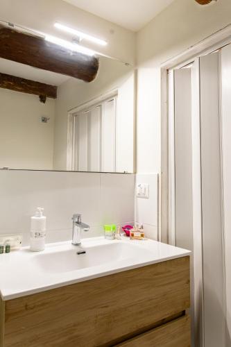 a bathroom with a white sink and a mirror at La Scogliera in Alghero