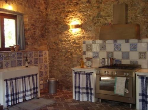 a kitchen with an oven and a stove top at Ferienwohnung La Taverna In Umbertide in Umbertide