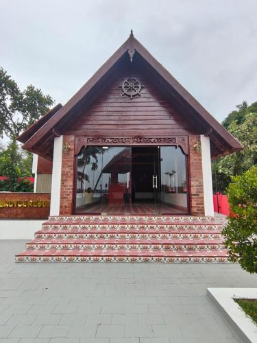 a small building with steps in front of it at Royce Resort in Paravūr