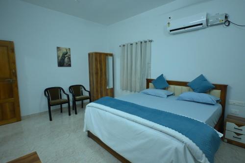 a bedroom with a large bed with blue lighting at Prashanthi Nature View - Luxury 2Bhk Villa in Udupi