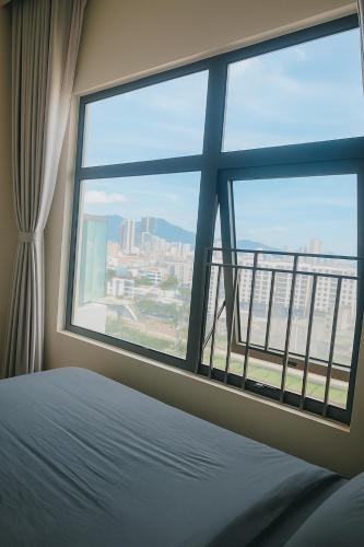 a bedroom with a window with a view of a city at Monarchy Luxury Serviced Apartments - By Charm Homestay Vietnam in Danang