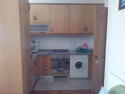 a kitchen with a stove and a washing machine at São Salvador in Porto