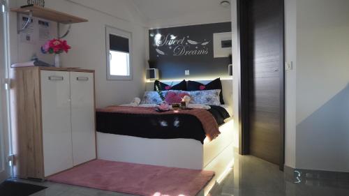 a small bedroom with a bed in a room at Apartment Sova or Deluxe room 33 in Bled