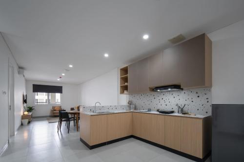 a kitchen with a large island in a room at Cove Nawaprita in Jakarta
