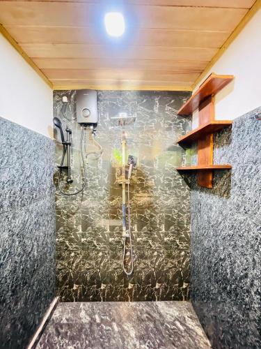 a bathroom with a shower with a sink and a shower at Villa Climax in Ahangama