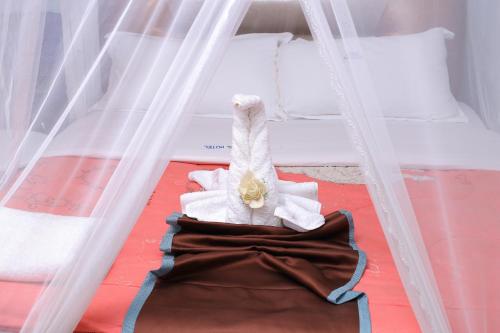 a childs bed with a stuffed animal laying on the floor at Jebel Hotel & Lounge Buloba in Kampala