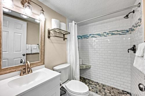 a bathroom with a toilet and a sink and a mirror at Lantana - 5251A in Siesta Key