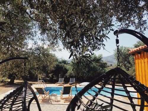 a view of a swimming pool with chairs next to at Wunderschönes Ferienhaus In Agios Stefanos in Foútia