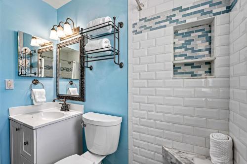 a bathroom with a toilet and a sink and a mirror at Plumbago - 5251C in Siesta Key