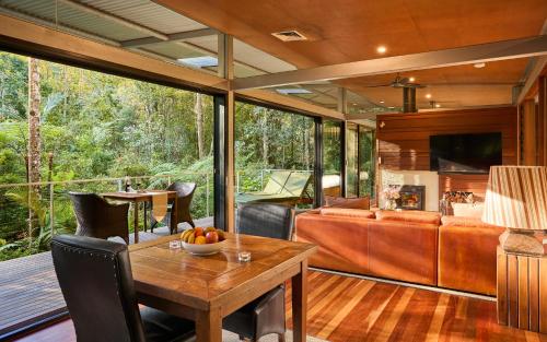 an open living room with a table and chairs at Crystal Creek Rainforest Retreat in Crystal Creek