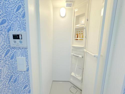 a bathroom with a refrigerator and a toilet at THE FEEL ONNA 2 / Vacation STAY 18776 in Onna