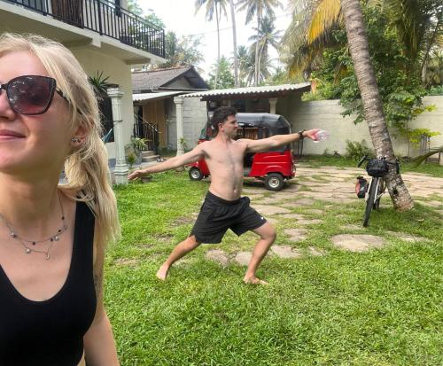 a woman standing next to a man throwing a frisbee at Wake N Flow, Ahangama - Kabalana Beach in Ahangama