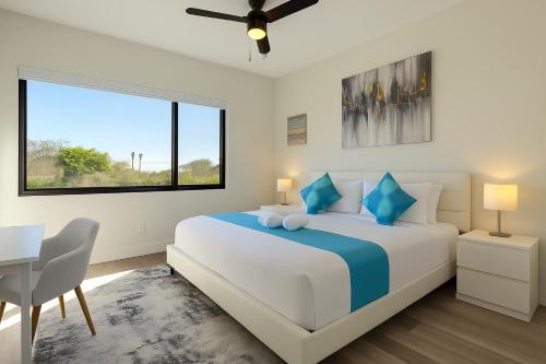 a white bedroom with a large bed and a desk at Lux place and cozy 3Beds 2Rooms enjoy life in WPB Gym, EV Station Nearby the downtown and beaches in West Palm Beach