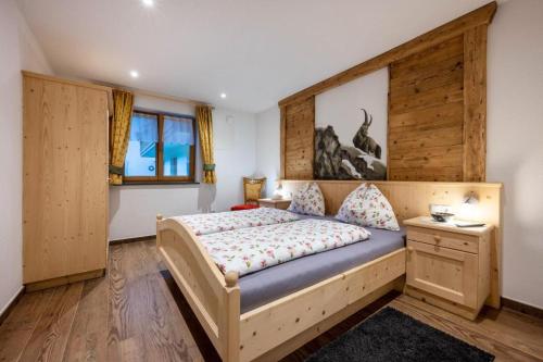 a bedroom with a bed and a window at Alpenappart in Cadipietra