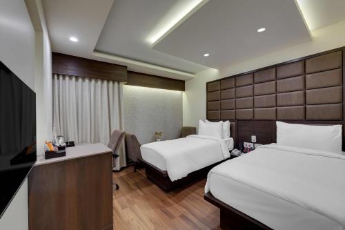 Ένα ή περισσότερα κρεβάτια σε δωμάτιο στο The Fern Residency Ellisbridge Ahmedabad