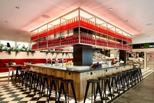 a bar in a restaurant with bar stools at citizenM London Victoria Station in London