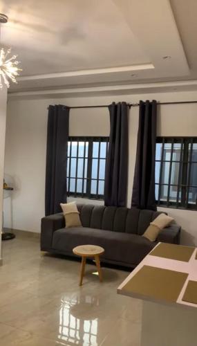 a living room with a couch and a table at Luxo in Cotonou