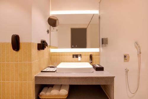 a bathroom with a sink and a shower at Lemon Tree Hotel, Ranchi in Rānchī