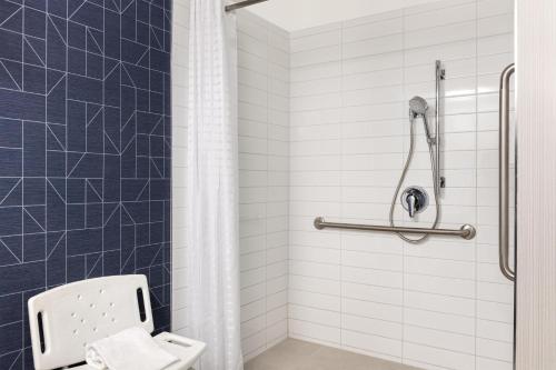 a bathroom with a white toilet and a shower at Spark by Hilton Toronto Mississauga in Mississauga