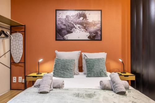 a bedroom with a large bed with pillows at L'éléhouse Studio Terrasse à RIOM in Riom