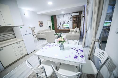 a kitchen and dining room with a table and chairs at Dracevo Apartments with Free Parking in Dračevo