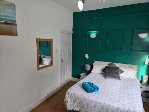 a bedroom with a bed with a blue backpack on it at Spacious Double Room in Anfield in Liverpool