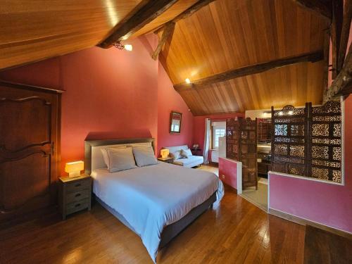 a bedroom with a white bed and red walls at Villa familiale La Finca du champ de l'eau Avec sauna jacuzzi proche de Disney et Paris in Crecy la Chapelle