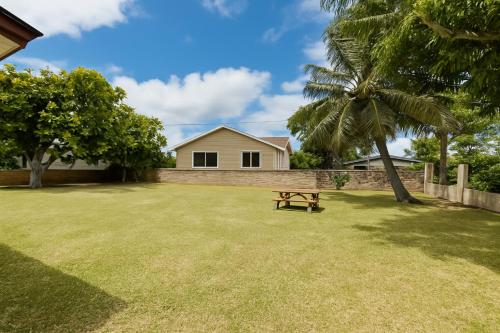 a picnic table in a yard with a house at Hale Moana Retreat AC Walk to Ocean and Spacious Family Stay in Laie