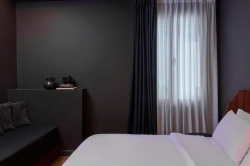 a bedroom with two beds and a window at Athens Icon Collection in Athens