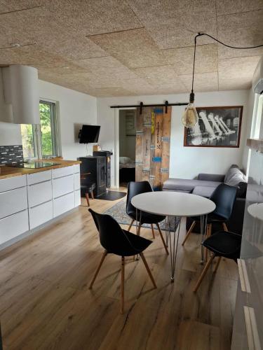 a kitchen and living room with a table and chairs at Danna house in Lejre