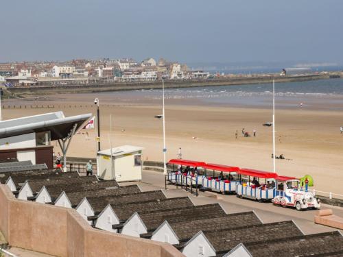 a bus on the beach with a beach in the background at Apt 5 Hunter's Quay in Bridlington