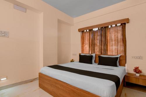 a bedroom with a large bed and a window at Collection O Biswa Bangla Convention Centre Kolkata Formerly Atithya Inn in New Town