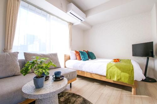 a living room with a bed and a couch at Mr Kintaro Hotel Kinshicho in Tokyo