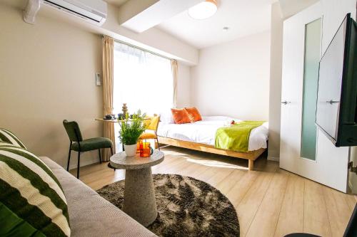 a living room with a bed and a table at Mr Kintaro Hotel Kinshicho in Tokyo