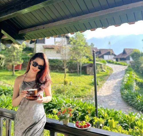 a woman in a silver dress holding a drink at Heaven House Sapa in Sapa