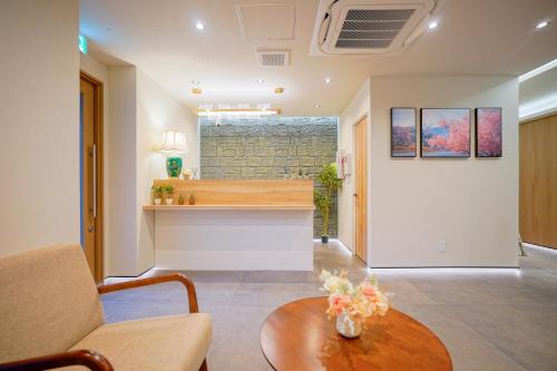 a living room with a table and a couch at Nakano World Hotel in Tokyo